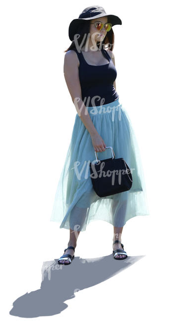 backlit woman in a light blue skirt standing