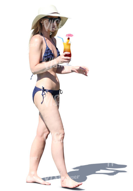 woman in a bikini walking with a cocktail in hand