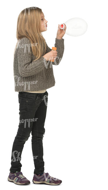 young girl standing and blowing soap bubbles