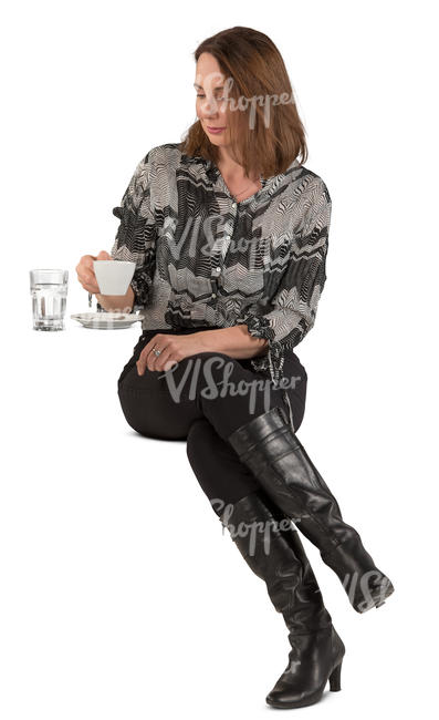 woman sitting in a cafe and drinking coffee