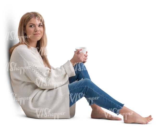 woman in a white pullover sitting and drinking coffee 