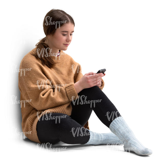 young woman in a sweater sitting and texting