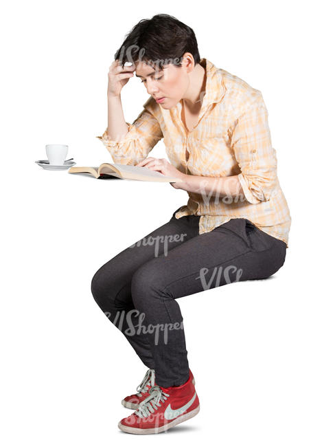 woman sitting in a cafe and reading a book