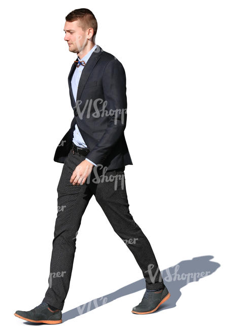 man in a suit walking on a sunny day