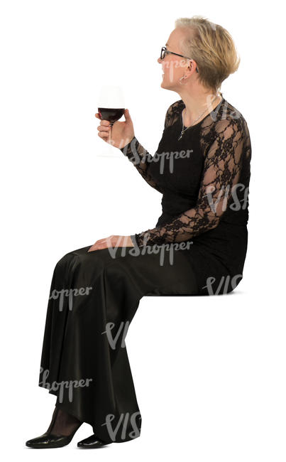 woman in a formal black dress sitting and drinking wine