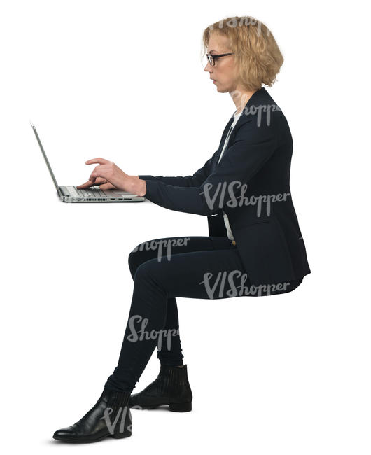 businesswoman sitting behind the desk and working on a computer