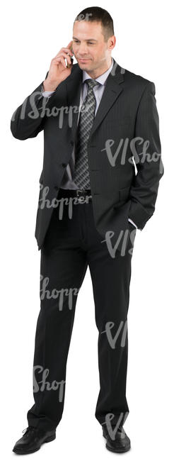 businessman in a suit standing and talking on the phone 