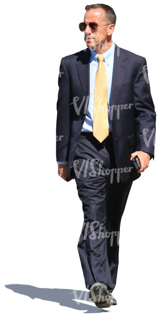 businessman in a dark blue suit walking