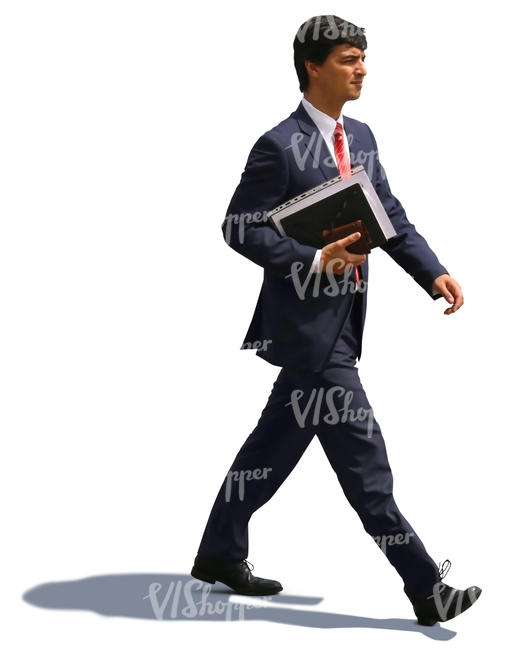 businessman with notebook under his arm walking hastily
