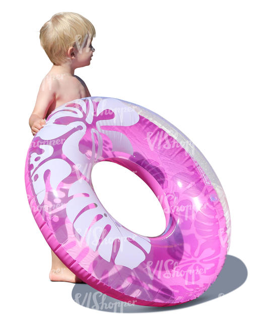 little boy with a swim ring standing in sunlight