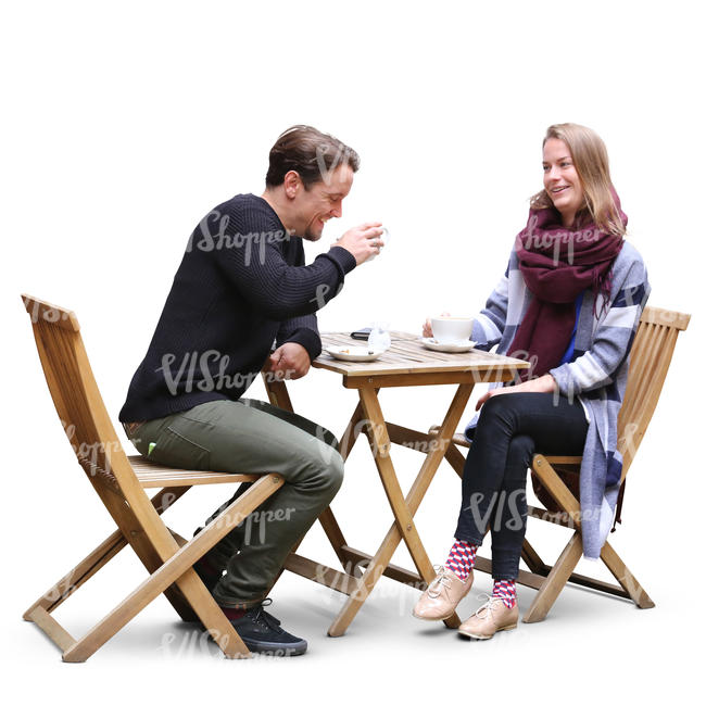 man and woman sitting in a street cafe