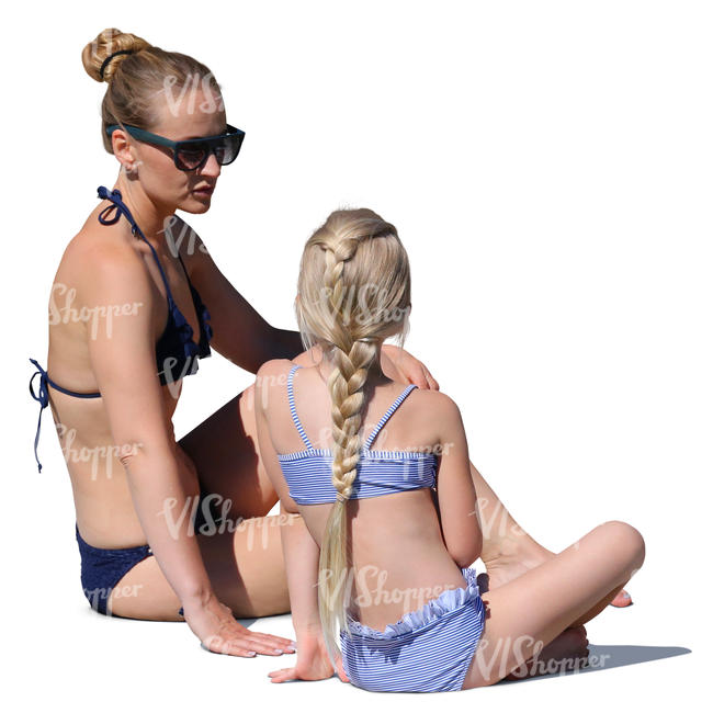 mother and daughter sitting on the beach