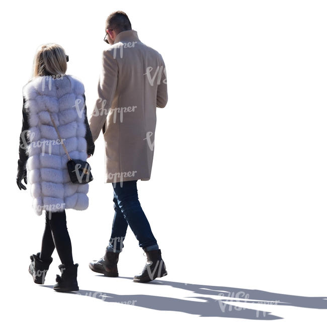 backlit man and woman walking