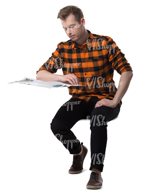 man sitting at a desk and reading a newspaper