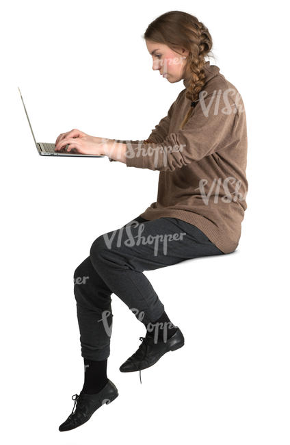 woman sitting and working with laptop at a bar counter