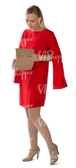 woman in a red dress standing and searching for smth in her purse