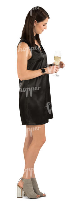 woman in a black party dress standing and drinking champagne