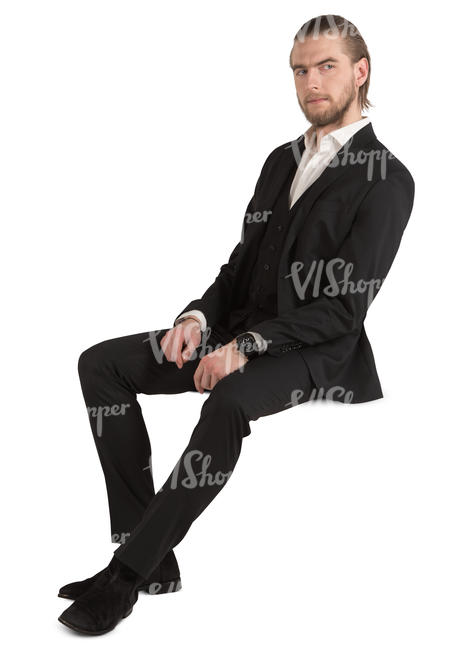 man in a black suit sitting