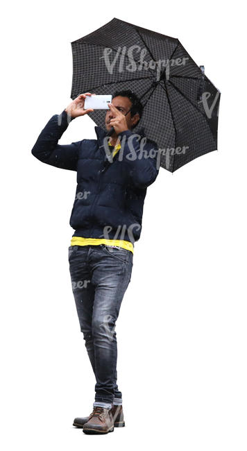 man with an umbrella taking a picture