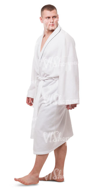 man in a white bathrobe walking