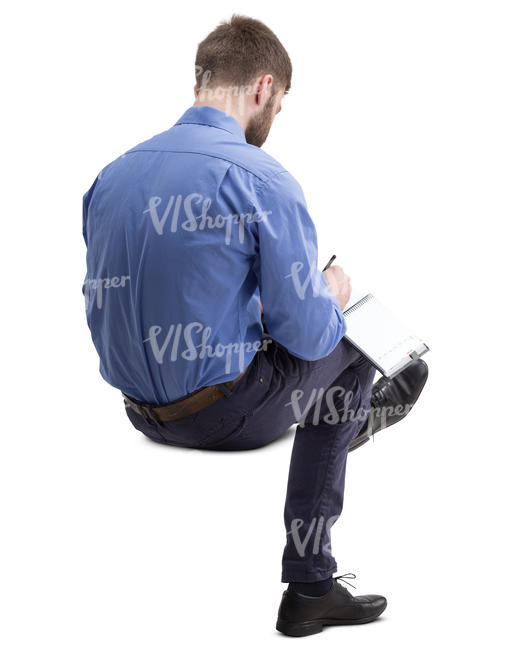 man sitting and taking notes