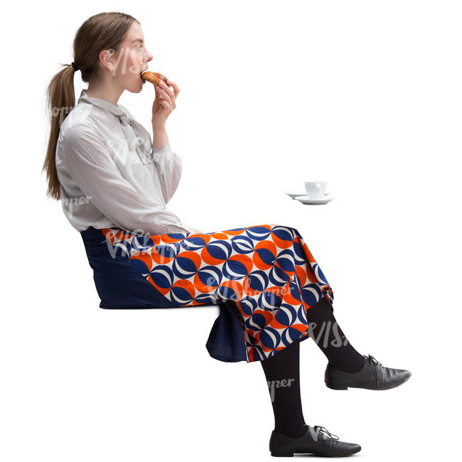 woman sitting in a cafe and eating danish pastry  