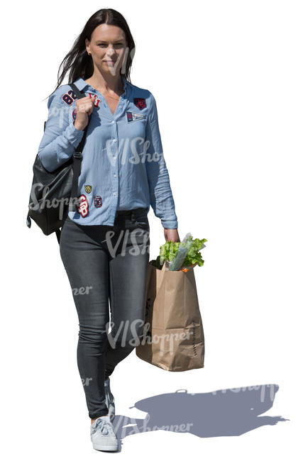 woman with a bag of groceries walking