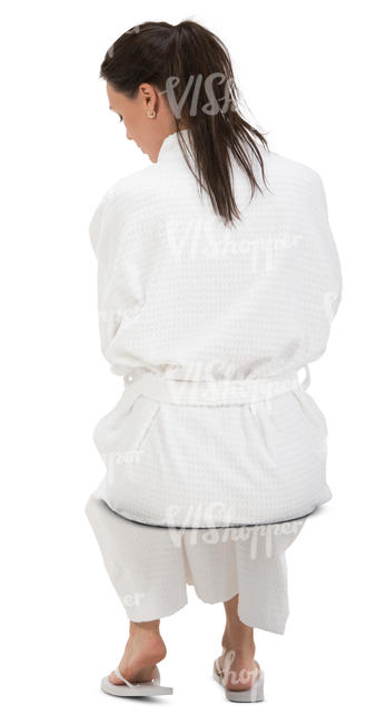 woman in a white bathrobe sitting