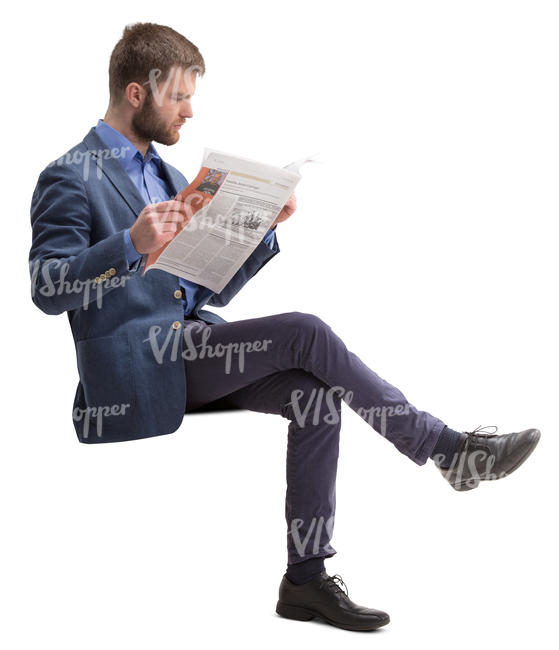 man in a suit sitting and reading a newspaper
