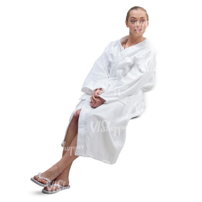 woman in a white bathrobe sitting