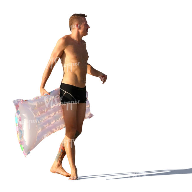 man in a bathing suit carrying a floatie 