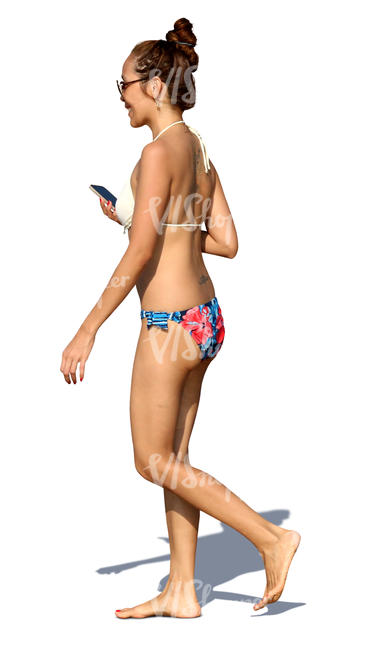 woman in a bikini walking and smiling