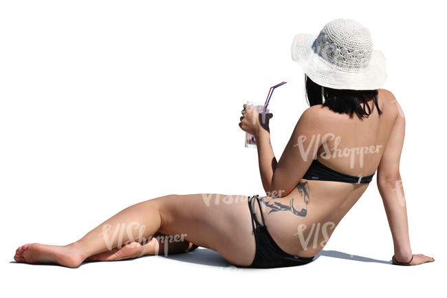 woman relaxing on the beach and drinking cocktail