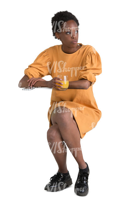 african woman sitting in a cafe and drinking juice