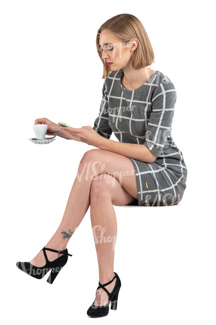 woman in a grey dress sitting in a cafe