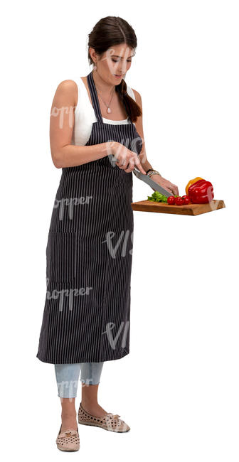 woman standing in a kitchen and slicing lettuce