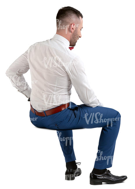 man in a suit and bow tie sitting