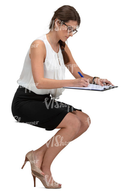 businesswoman sitting at a desk and writing