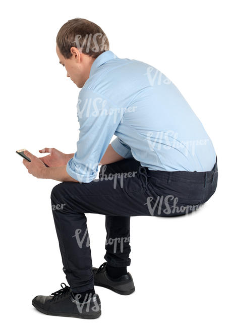 young man sitting and texting
