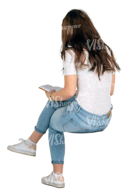 woman sitting and reading a book seen from behind