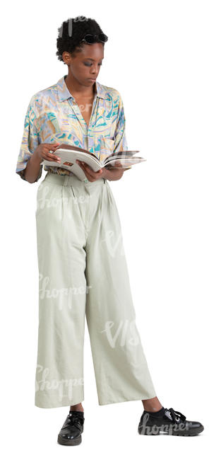 african woman standing and reading a magazine