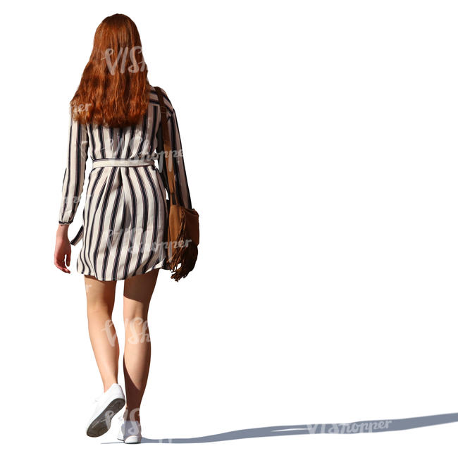 woman with long red hair walking
