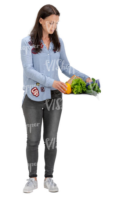 woman laying vegetables on a kitchen table
