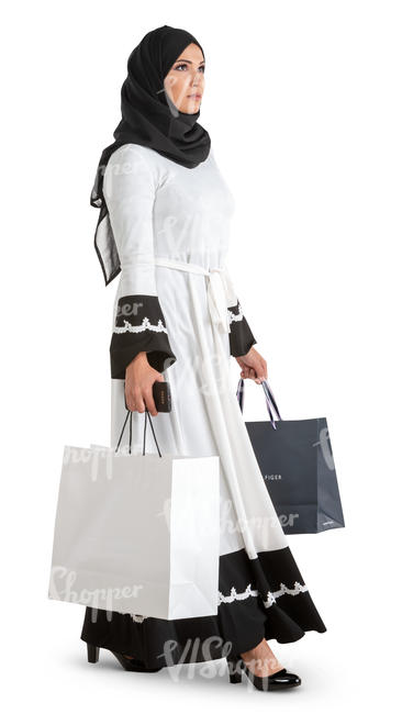 muslim woman in a black and white costume walking