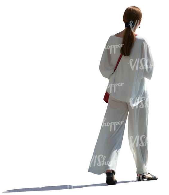 backlit woman in a white costume walking