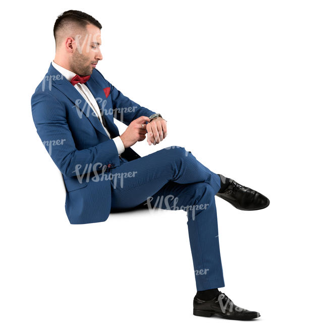 man in a blue suit sitting and checking his watch