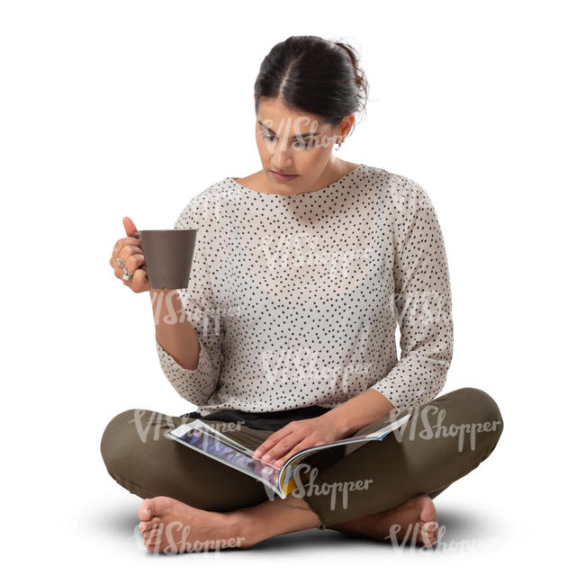 woman sitting on a floor and reading a magazine