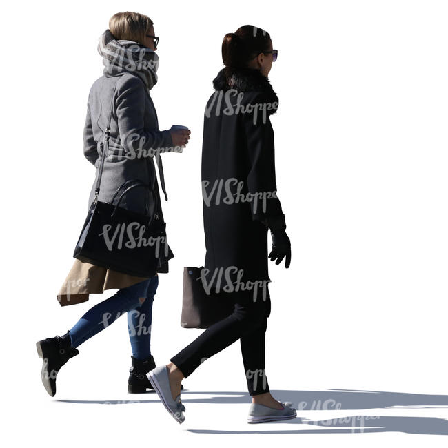 two sidelit women walking