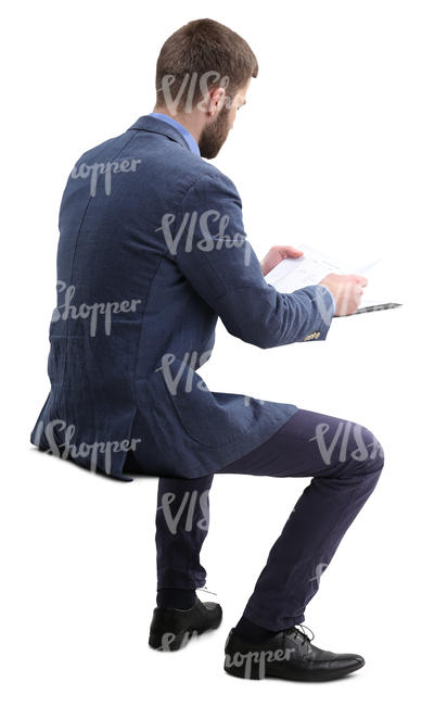 man sitting and reading paperwork