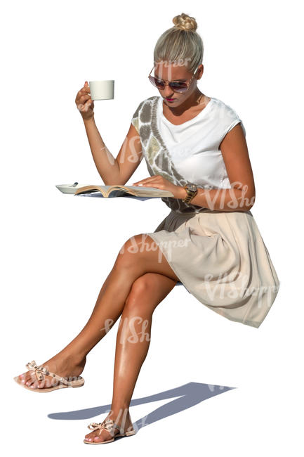 woman drinking coffee and reading a magazine